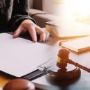 Business and lawyers discussing contract papers with brass scale on desk in office. Law, legal services, advice, justice and law concept picture with film grain effect